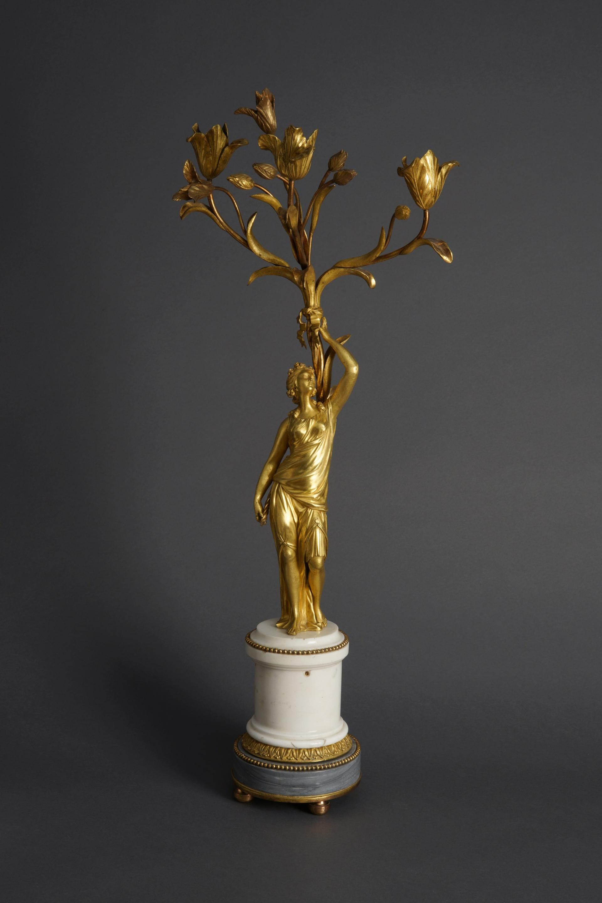 Канделябр.  Фигура нимфы выполнена по модели Этьена Мориса Фальконе (1716–1791)  Франция, Париж  1780-е  Бронза, белый мрамор, серый мрамор, литьё, чеканка, матовое и глянцевое огневое золочение.